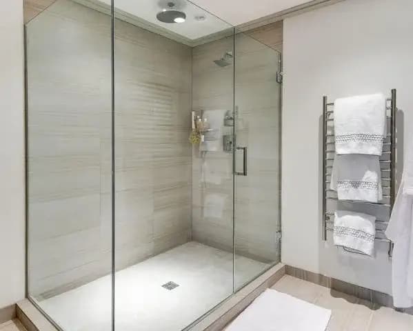 Glass shower enclosure with tiled walls
